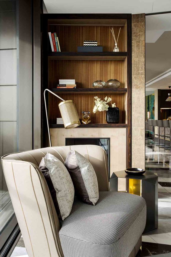Small display unit housing collection of Objéts, lined in a delicate stripe fabric wall covering