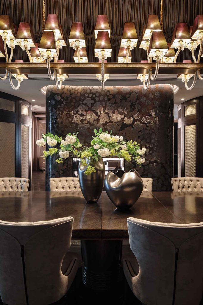 Metalised dining table, modern Murano chandelier, mosaic fire place, suede dining chairs