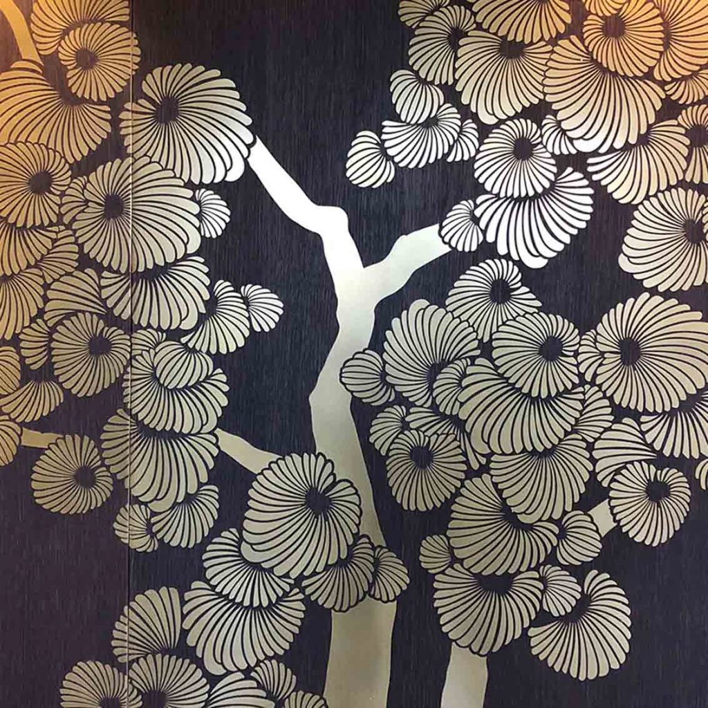 Dark oak panelled walls with inlaid satin brass Gingko tree design